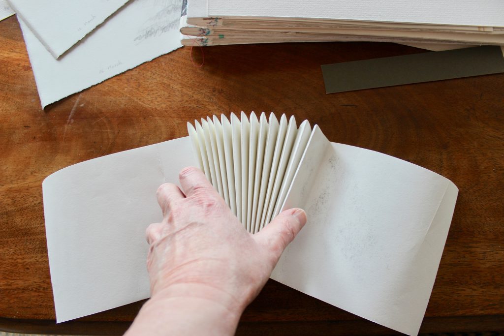 The spines are sewn by machine and then the sketches are sewn in by hand