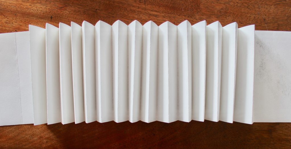 I fold paper in concertina fashion to form the spine of the sketchbook